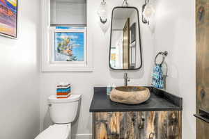 Half bathroom with toilet and vanity