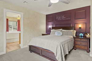 Carpeted bedroom featuring baseboards and a ceiling fan
