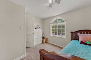 Bedroom featuring light carpet and a textured ceiling