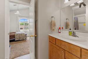 Ensuite bathroom with vanity, a shower with shower curtain, and light tile patterned flooring
