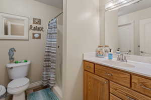Full bath with vanity, a shower stall, and tile patterned floors