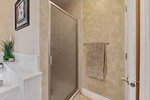 Full bath with a stall shower and vanity