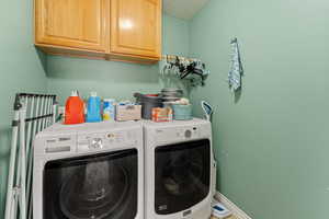 Laundry room featuring cabinet space and washer and dryer