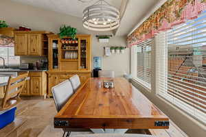 Dining room with stone tile floors and a chandelier