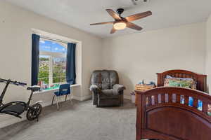 Bedroom featuring carpet flooring, a ceiling fan, and a textured ceiling