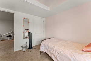 Bedroom featuring carpet and baseboards