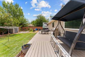 Deck with outdoor dining area, a patio, and an outdoor structure