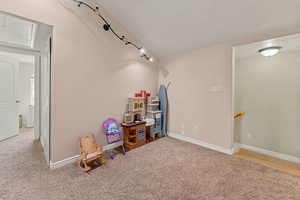 Game room with light colored carpet and attic access