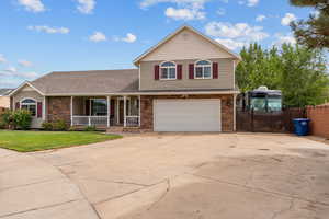 View of front of house featuring covered porch, driveway, an attached garage, a gate, and a shingled roof