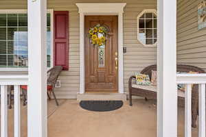 Property entrance with covered porch