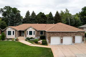 Single story home featuring a garage, a front yard, concrete driveway, a shingled roof, and brick siding