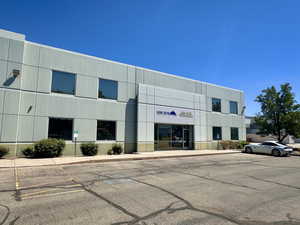 View of commercial property featuring uncovered parking