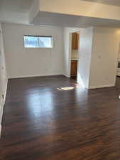 Empty room featuring dark wood-type flooring