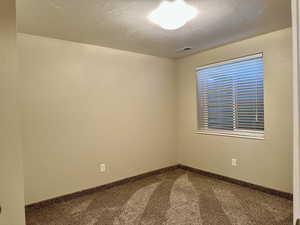 Bedroom with carpet flooring and a textured ceiling