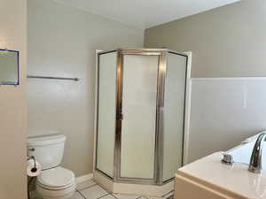 Master bathroom featuring tile patterned floors and a stall shower, bathtub and vanity