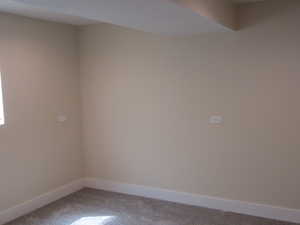 Unfurnished room with carpet and baseboards