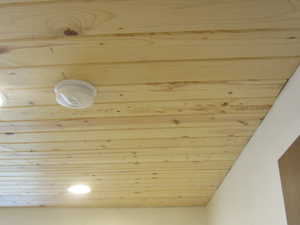 Detailed view of wood ceiling and a smoke detector