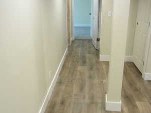 Hall featuring baseboards and light wood-type flooring
