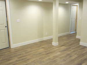 Finished below grade area with dark wood-style floors