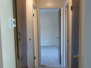 Corridor featuring carpet flooring
