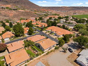 Aerial view of property's location featuring nearby suburban area and a mountain backdrop