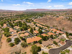 Aerial overview of property's location with nearby suburban area and mountains