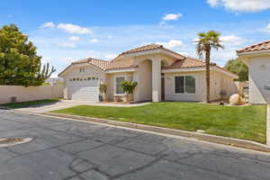 Mediterranean / spanish house with driveway, a tiled roof, stucco siding, and an attached garage