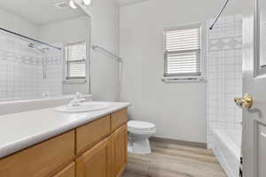 Bathroom with vanity, tub / shower combination, and light wood finished floors