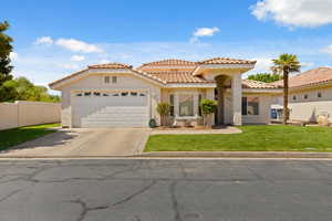 Mediterranean / spanish house featuring stucco siding, concrete driveway, an attached garage, and a tile roof