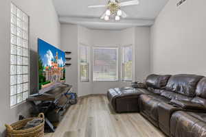 Living room featuring light wood-style flooring and a ceiling fan