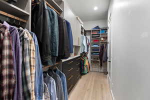 Spacious closet with light wood finished floors