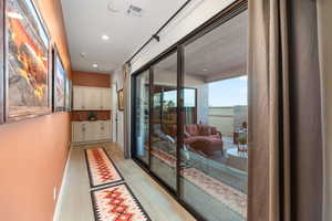Doorway to outside with hardwood / wood-style floors and recessed lighting