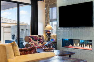 Living room featuring a glass covered fireplace