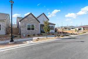 View of front facade with board and batten siding, a residential view, and stone siding