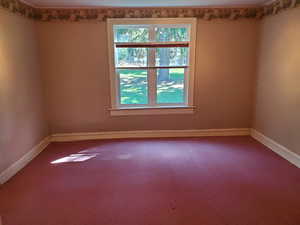 Unfurnished room with baseboards