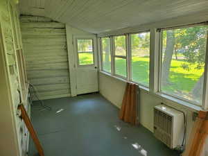 Unfurnished sunroom with vaulted ceiling