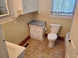 Half bath featuring vanity and tile walls
