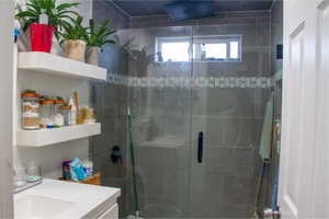 Full bath with a stall shower and vanity