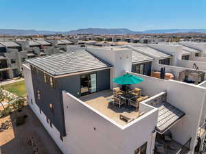 Front of house featuring a residential view, a patio area, stucco siding, and a mountain view