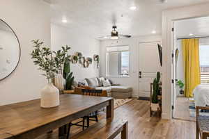 Dining area featuring light wood-type flooring, a textured ceiling, a ceiling fan, and recessed lighting