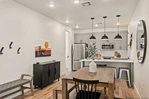 Dining space featuring light wood-style floors and recessed lighting
