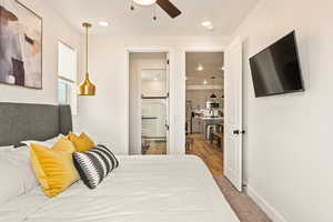 Bedroom featuring recessed lighting, light carpet, ceiling fan, and connected bathroom