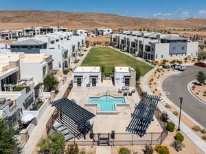 Aerial view of residential area featuring a mountain backdrop and large spa area