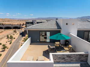 Top of house with a patio, a mountain view, and stucco siding