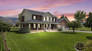 Farmhouse inspired home featuring a large porch, concrete driveway, a front lawn, a garage, and roof with shingles