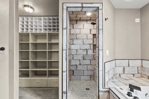 Full bathroom with a shower stall and a garden tub