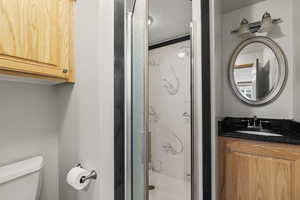 Bathroom featuring vanity and a stall shower