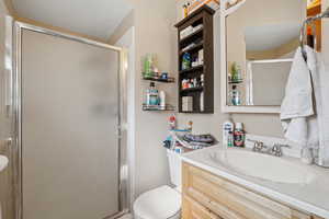 Bathroom featuring vanity and a stall shower