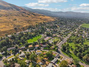 Aerial view of property's location featuring nearby suburban area and mountains