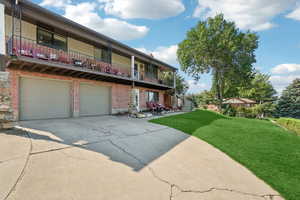 View of property with concrete driveway and an attached garage